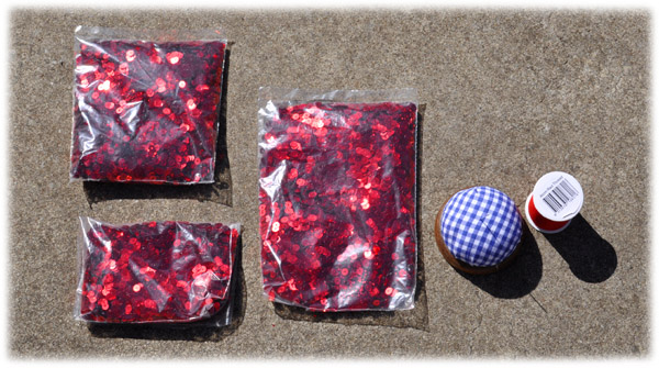 Bags of red metallic sequins